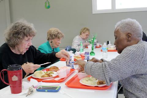 Older adults having a meal together at a senior center