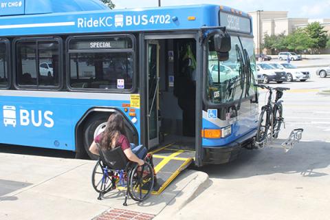 Person in wheelchair entering bus