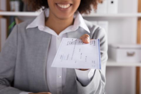 Woman holding a paycheck
