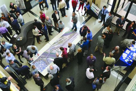 People gathered around table reviewing plan for Buck O'Neil Bridge