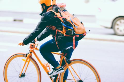 Person riding a bike with backback