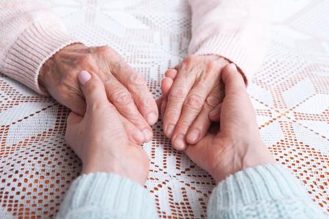 holding hands with older adult