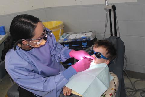 A child receiving dental services at a mobile dentist event
