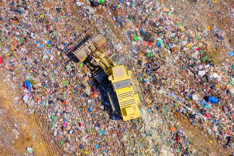 An aerial view of a tractor in a landfill