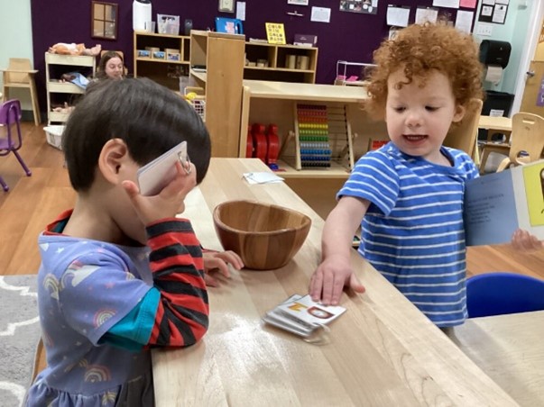 Children in an early learning facility playing with books