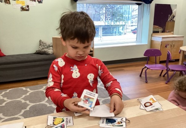 Children in an early learning facility playing with books