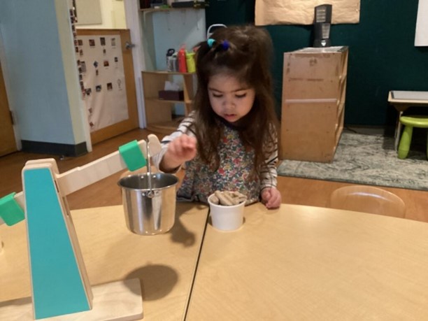 Two children play with measuring materials