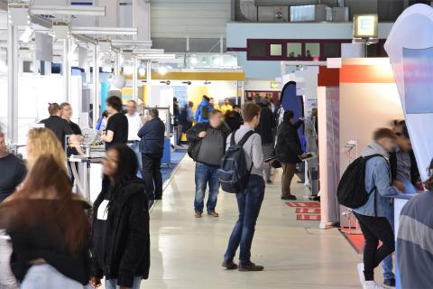 People exploring a trade or job fair