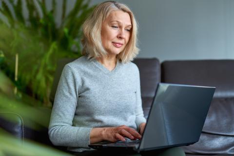 An older woman using a laptop