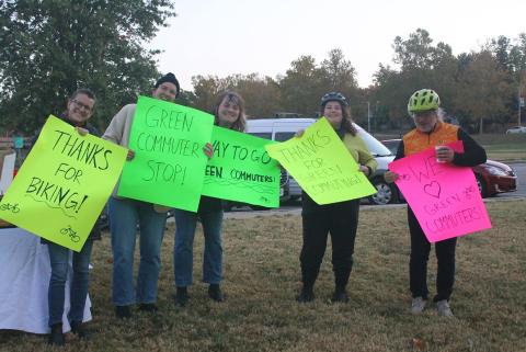 People holding signs for the Green Commuter Stop during the 2024 Green Commute Challenge. 