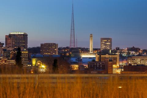 A view of downtown Kansas City at dusk with brown native grass in the foreground