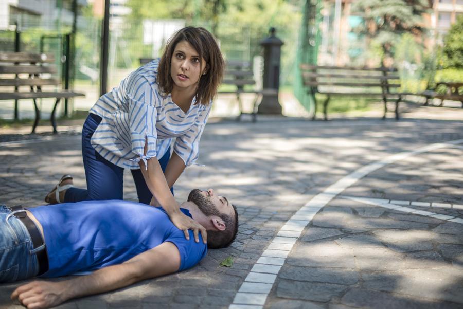 Woman helping an unconscious man