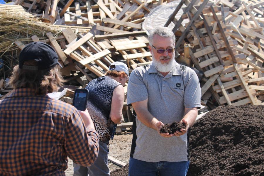 Kevin Anderson holds finished compost outside of material dumping grounds at Missouri Organic Recycling