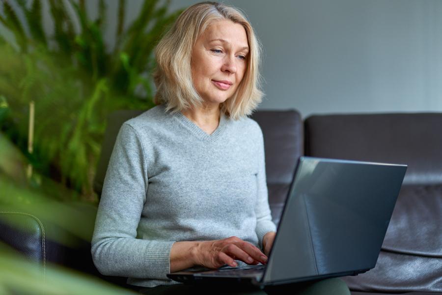 An older woman using a laptop