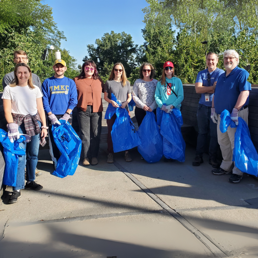 Volunteer group poses with trash bags ahead of Berkley Riverfront Park cleanup