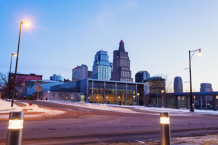 A wintry image of the Kansas City skyline with light snow on the ground