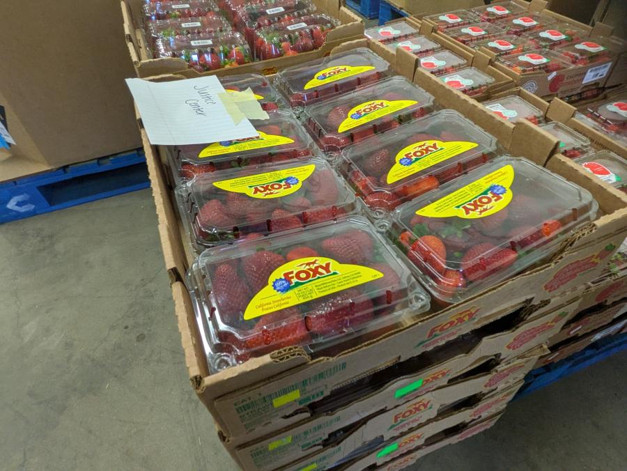 Strawberry containers stacked high on a pallet